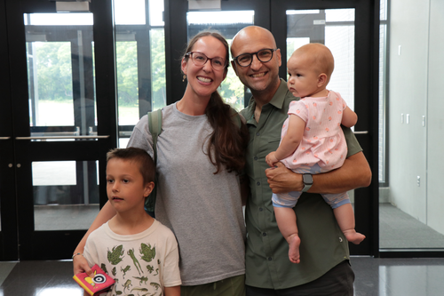 Two parents and two children smile at the camera